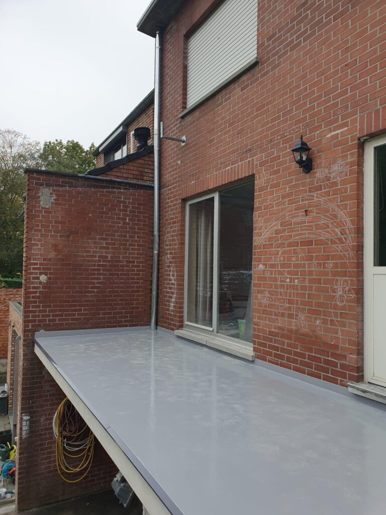 Gerenoveerd betonnen terras na terrasrenovatie met nieuwe waterdichte afwerking aan een woning.